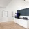 a room with a wood floor and a stand alone black wall