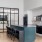 a kitchen with a bar and chairs